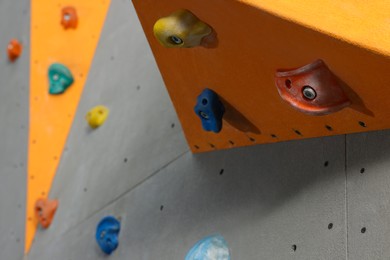 Climbing wall with holds, closeup. Extreme sport