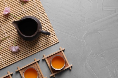 Beautiful traditional tea ceremony arrangement on light grey table, flat lay. Space for text