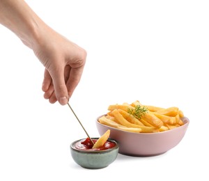 Woman dipping french fries into ketchup on white background, closeup