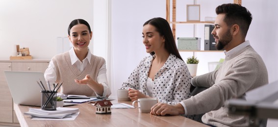 Image of Coworkers at wooden table in office. Banner design
