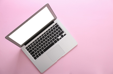Modern laptop with blank screen on pink background, top view