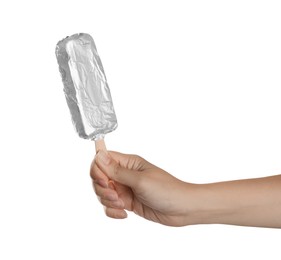 Woman holding ice cream wrapped in foil on white background, closeup