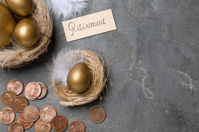 Many golden eggs, coins and card with word Retirement on grey table, flat lay. Pension concept