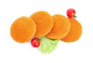 Photo of Uncooked breaded cutlets, tomatoes and lettuce on white background, top view. Freshly frozen semi-finished product