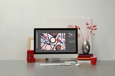 Designer's workplace. Computer with photo editor application on table 
