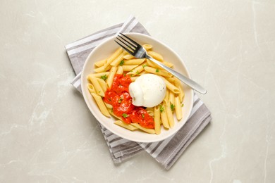 Delicious pasta with burrata cheese and sauce on light grey table, top view
