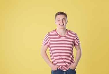 Portrait of teenage boy on yellow background