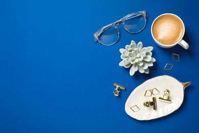 Flat lay composition with classic black coffee and space for text on blue background. Color of the year 2020