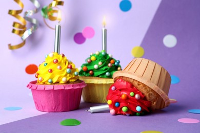 Dropped cupcake among good ones on color background. Troubles happen