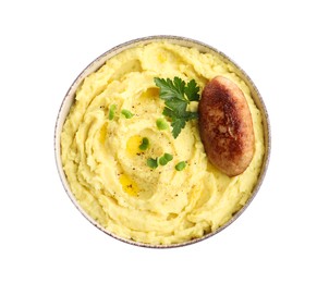 Photo of Bowl of tasty mashed potatoes with parsley, black pepper and cutlet on white background, top view