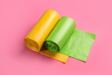 Rolls of garbage bags on pink background