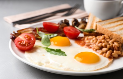 Tasty breakfast with fried eggs on table, closeup