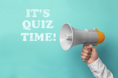 Phrase IT'S QUIZ TIME and man holding megaphone on turquoise background, closeup 
