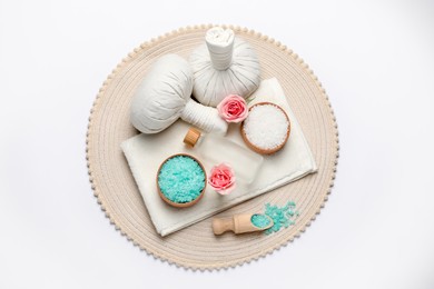 Beautiful spa composition with herbal massage bags and different care products on white background, top view
