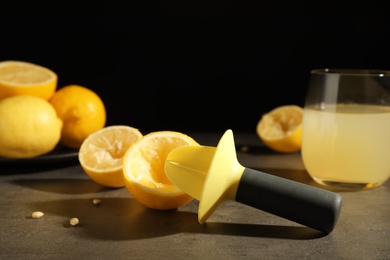 Fresh lemon half with juicer on table. Refreshing drink recipe