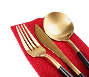 Photo of Red napkin with golden cutlery on white background, closeup
