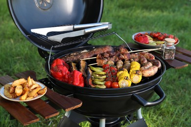 Tasty meat and vegetables on barbecue grill outdoors