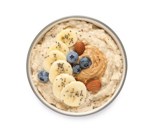 Tasty oatmeal porridge with different toppings in bowl on white background, top view