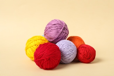Soft colorful woolen yarns on beige background