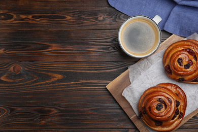 Delicious pastries and coffee on wooden table, flat lay. Space for text