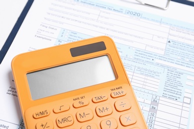 Calculator and document on table, closeup view. Tax accounting