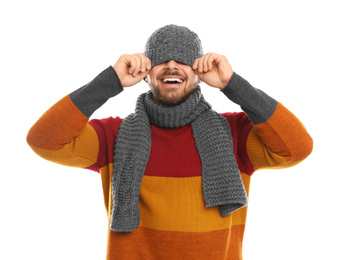 Emotional young man in warm clothes on white background. Winter vacation
