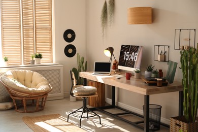 Room interior with comfortable workplace. Modern computer and laptop on wooden desk