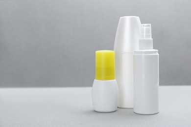 Set of different insect repellents on grey background. Space for text