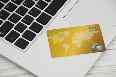 Photo of Online payment concept. Bank card with laptop on white wooden table, closeup