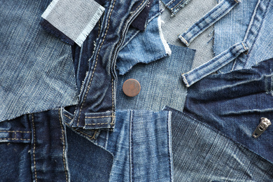 Photo of Many patches of old jeans as background, top view
