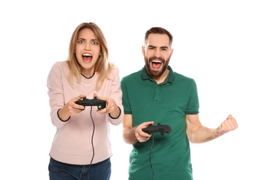Emotional couple playing video games with controllers isolated on white