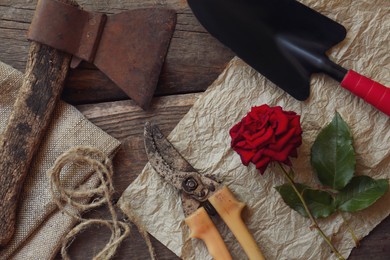 Flat lay composition with old secateurs and other gardening tools on wooden table