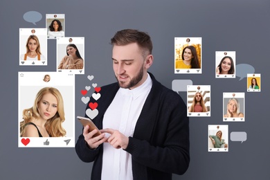 Image of Handsome man visiting online dating site via smartphone on grey background