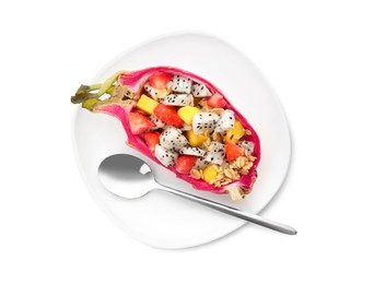 Yummy pitahaya boat with mango, granola and strawberry near spoon on white background, top view
