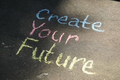 Photo of Phrase Create Your Future written on asphalt