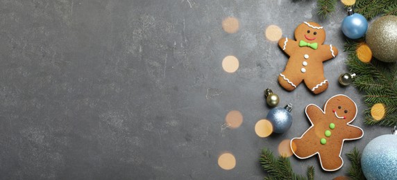 Image of Flat lay composition with gingerbread men on grey table, space for text. Banner design