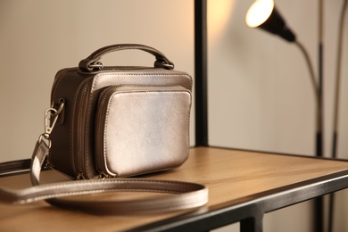 Elegant grey bag on shelf in luxury boutique