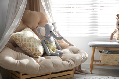 Beautiful baby room interior with comfortable armchair and bench near window