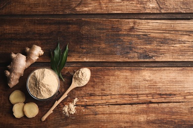 Dry ginger powder, fresh root and leaves on wooden table, flat lay. Space for text