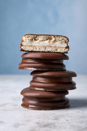 Stack of tasty choco pies on grey table