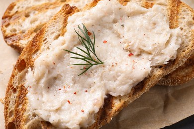 Photo of Toast with lard spread on parchment, closeup