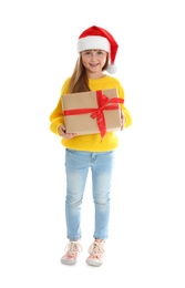 Cute little girl in Santa hat with Christmas gift on white background