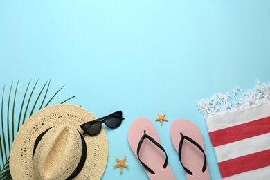 Photo of Flat lay composition with different beach objects on light blue background, space for text
