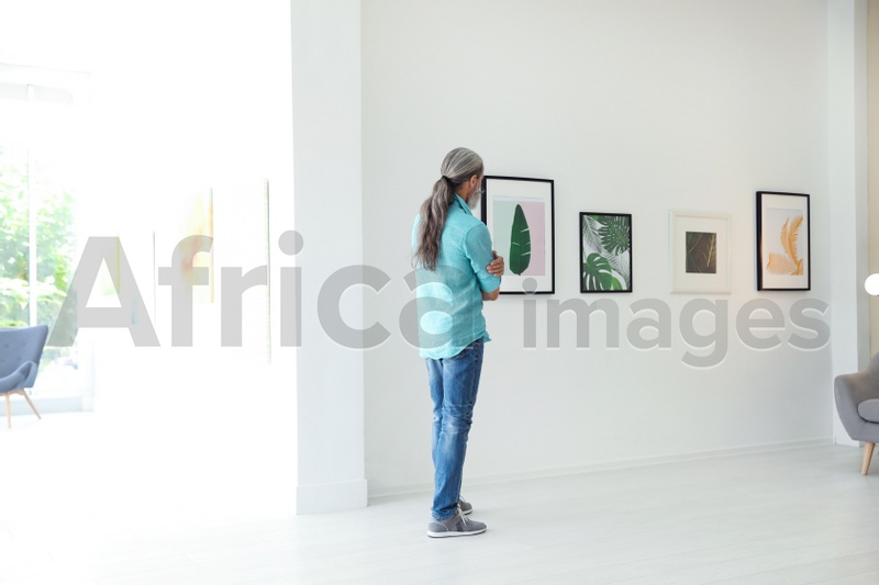 Senior man at exhibition in art gallery