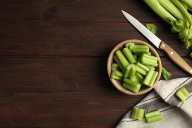 Photo of Fresh ripe green celery on wooden table, flat lay. Space for text