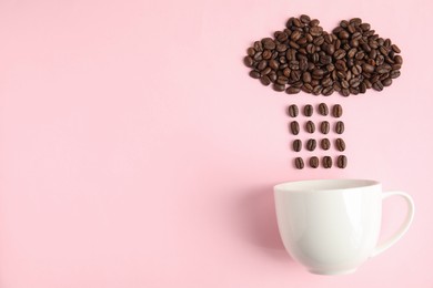 Cloud and raindrops made of coffee beans falling into cup on pink background, flat lay. Space for text