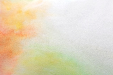 Colorful paints on white paper. Abstract background