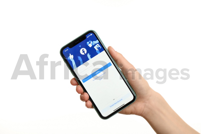 Photo of MYKOLAIV, UKRAINE - JULY 9, 2020: Woman holding  iPhone X with Facebook app on white background, closeup