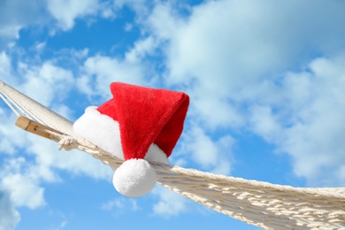 Rope hammock with Santa's hat outdoors, closeup. Christmas vacation