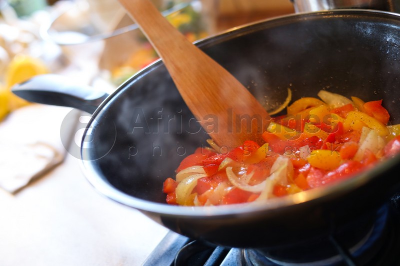 Photo of Cooking fresh vegetables in frying pan on stove, closeup